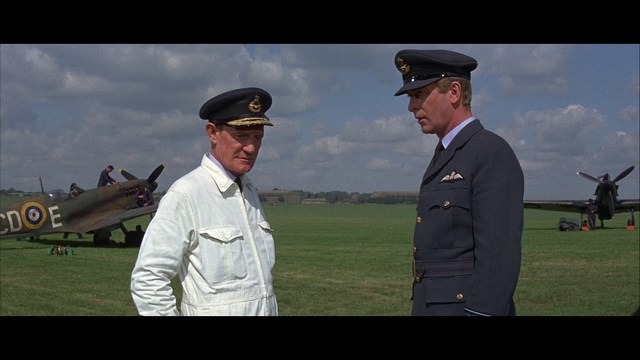 Scene from the movie featuring two characters, one with a beard and the other with long hair, both wearing red bandanas and looking surprised.