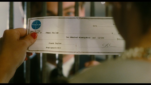 A worried woman stands on a deserted road, looking shocked or distressed as she gazes into the distance.