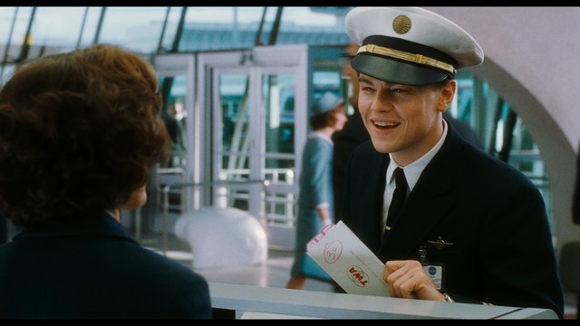 Three characters looking down with surprised expressions, framed from below.