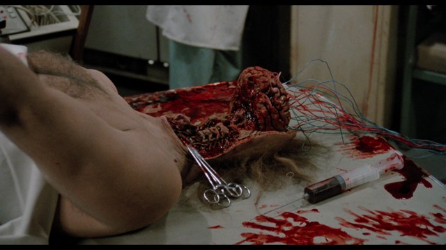 A young man pointing a handgun while seated in a bus, showcasing an intense expression.