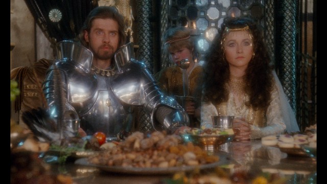 A group of characters in futuristic gear, looking tense and alert, possibly in a sci-fi setting.
