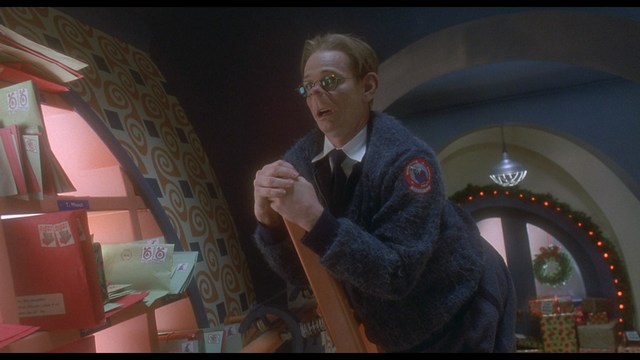 A person holding a newspaper article titled 'Mooby: Creating an Empire Out of Simplicity' featuring a chart showing growth, alongside an image of a cartoon cow.