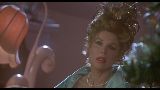 A still image from a film featuring a somber-looking man with dark hair, wearing a hoodie, expressing a concerned or troubled emotion.