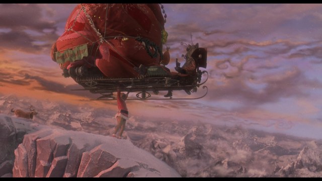 A close-up of a man wearing a red cardinal's hat and black clerical robes, seated in a leather armchair with a serious expression, in an office setting adorned with colorful posters.