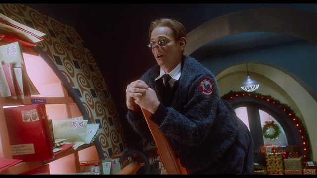 A close-up of a person's hand holding a crumpled newspaper with the headline "Mooby's: Creating an Empire Out of Simplicity" and a graphical chart showcasing growth, titled "It was a very Good YEAR."