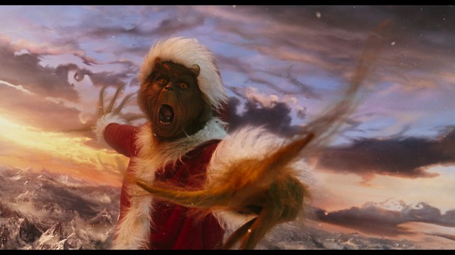 Two characters sitting at a table, one holding a small statue, with a surprised expression. The background features vibrant colors and patterns.