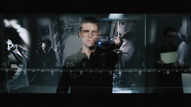 A large statue of a smiling man with long hair and a beard, giving a thumbs-up gesture, set against a background featuring colorful religious-themed posters.