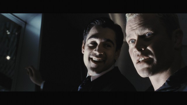 A still image from a film featuring a somber-looking man with dark hair, wearing a hoodie, expressing a concerned or troubled emotion.