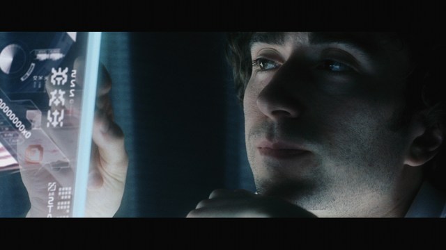 Scene featuring three characters on a roadside, discussing animatedly. A green landscape is visible in the background.