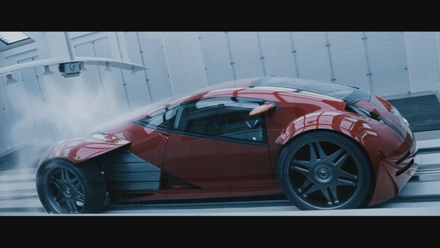 A futuristic red car in a high-tech environment, showcasing sleek design elements and advanced technology.