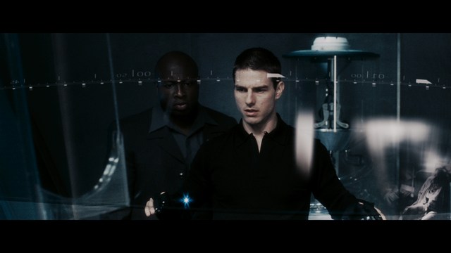 Four anthropomorphic turtles in ninja attire stand in a dimly lit room, while a humanoid character with fur sits nearby.