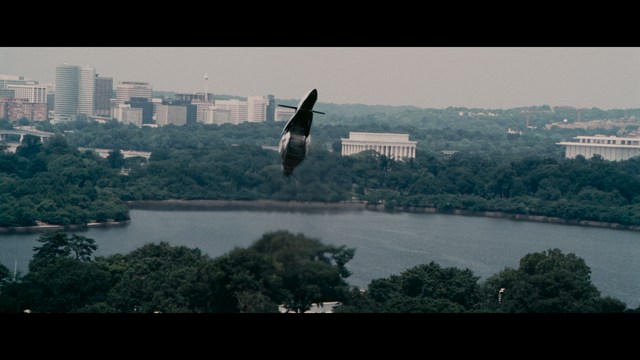 Two characters sitting in a diner, one wearing a blue beanie with 'SNOOGANS' and the other wearing a cap, both looking intently at something off-screen.