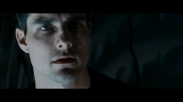 Two characters wearing red bandanas look surprised while standing in a dimly lit indoor setting.