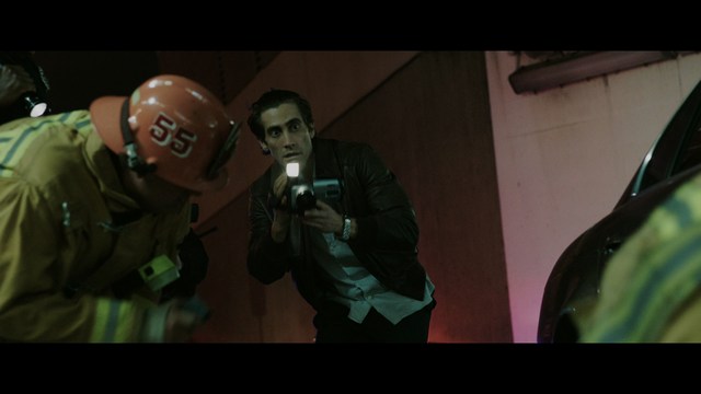 A scene featuring five characters in a bar setting, with a focus on their expressions and interactions. The backdrop includes bar shelves with bottles and a bartender visible in the background.