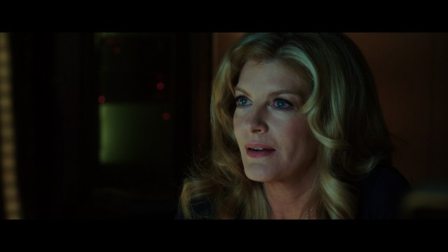 Aerial view of futuristic skyscrapers with cars driving vertically up the side of a building, showcasing a modern urban landscape.