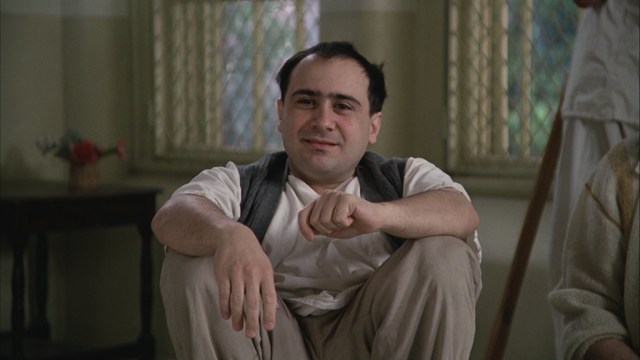 Scene from the movie featuring two characters, one with a beard and the other with long hair, both wearing red bandanas and looking surprised.