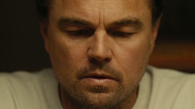 A close-up of a person's hand holding a crumpled newspaper with the headline "Mooby's: Creating an Empire Out of Simplicity" and a graphical chart showcasing growth, titled "It was a very Good YEAR."