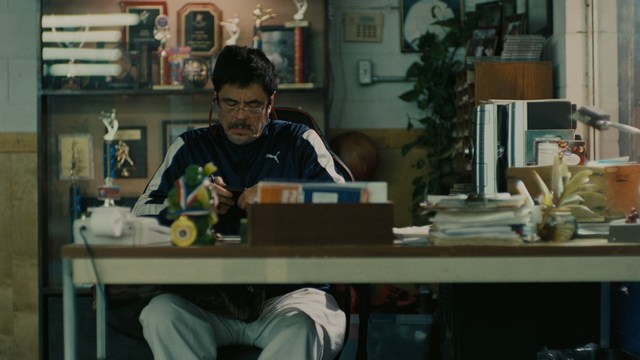 A scene featuring five characters in a bar setting, with a focus on their expressions and interactions. The backdrop includes bar shelves with bottles and a bartender visible in the background.