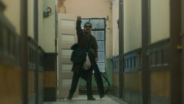 Two characters wearing red bandanas look surprised while standing in a dimly lit indoor setting.