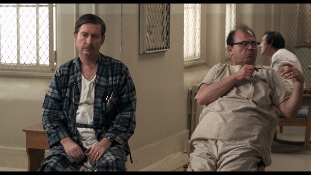 A close-up of a person's hand holding a crumpled newspaper with the headline "Mooby's: Creating an Empire Out of Simplicity" and a graphical chart showcasing growth, titled "It was a very Good YEAR."