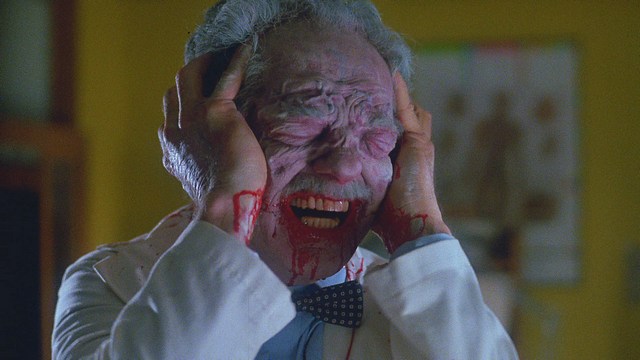 A scene featuring a man dressed as a cardinal, standing in front of a building with signs related to Catholicism.