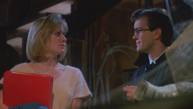 A still image from a film featuring a somber-looking man with dark hair, wearing a hoodie, expressing a concerned or troubled emotion.