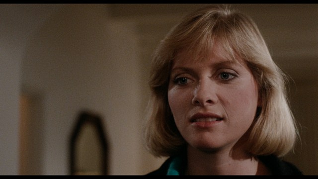 A young man pointing a handgun while seated in a bus, showcasing an intense expression.