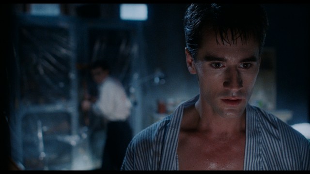 A worried woman stands on a deserted road, looking shocked or distressed as she gazes into the distance.