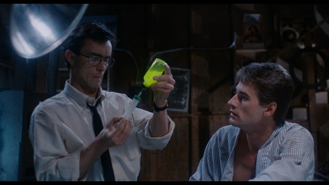 A scene featuring a man with short hair and a beard, wearing a brown jacket and purple shirt, standing outside a restaurant with bright yellow walls and a cartoon cow logo.