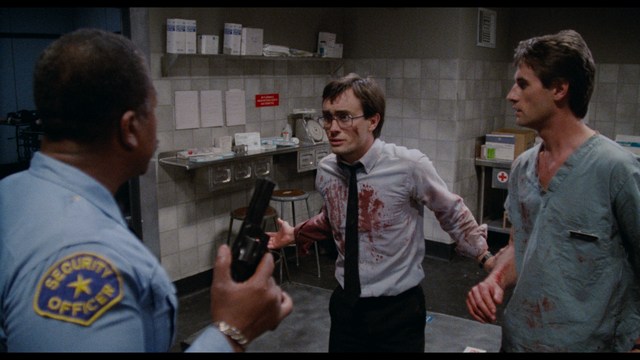 Two characters wearing red bandanas look surprised while standing in a dimly lit indoor setting.