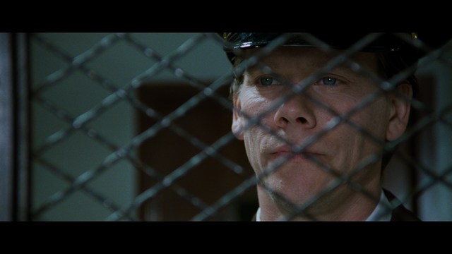 Two characters wearing red bandanas look surprised while standing in a dimly lit indoor setting.