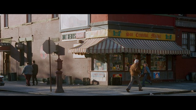 Scene featuring a character in a glowing white robe with long hair, standing in a futuristic environment at night with a city skyline in the background.