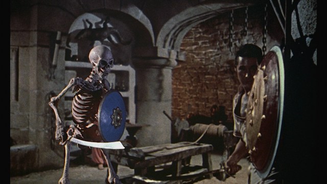 A close-up of several hands gripping and interacting with a gory, bloodied scene, depicting a violent or traumatic moment.