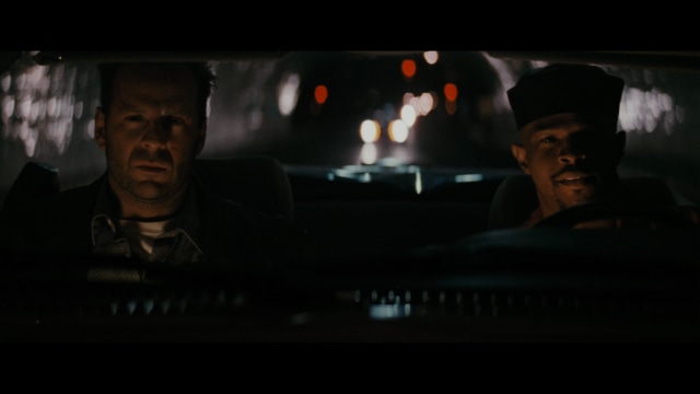 Two characters wearing red bandanas look surprised while standing in a dimly lit indoor setting.