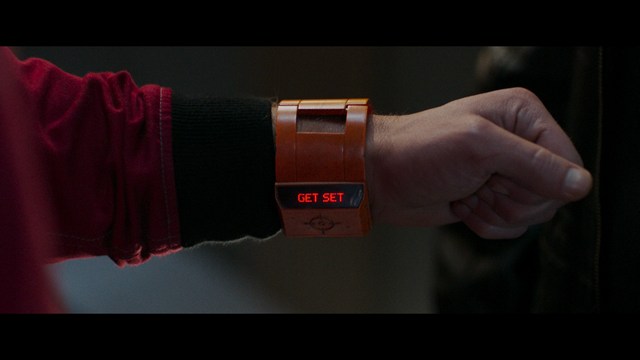 Three characters looking down with surprised expressions, framed from below.