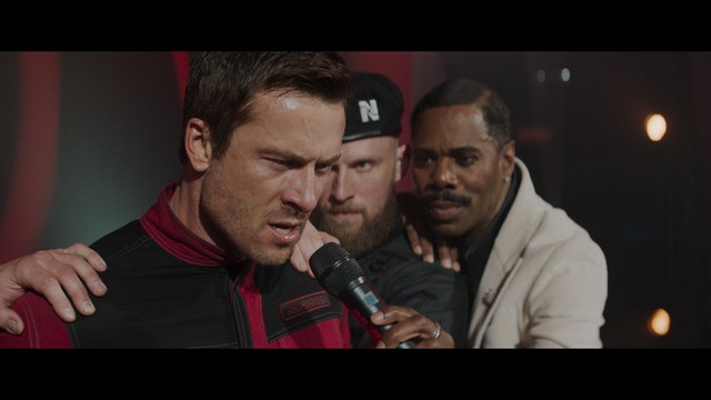 Two characters wearing red bandanas look surprised while standing in a dimly lit indoor setting.