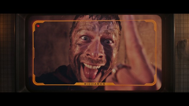 A group of characters in futuristic gear, looking tense and alert, possibly in a sci-fi setting.