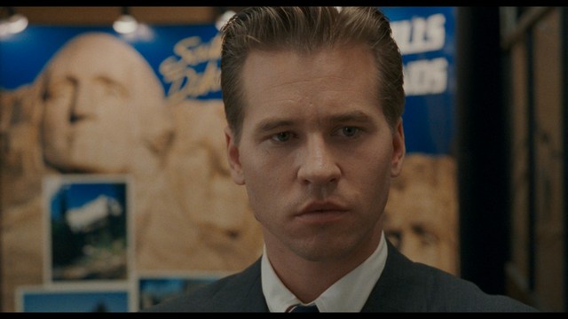 A close-up of a person's hand holding a crumpled newspaper with the headline "Mooby's: Creating an Empire Out of Simplicity" and a graphical chart showcasing growth, titled "It was a very Good YEAR."