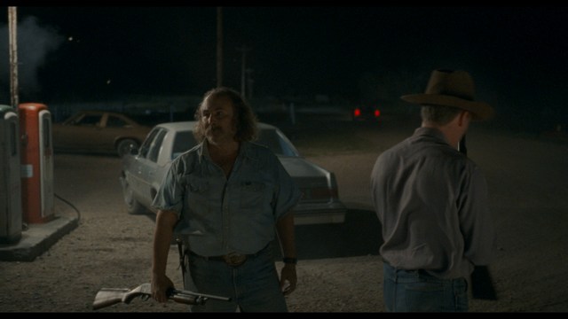 A scene featuring five characters in a bar setting, with a focus on their expressions and interactions. The backdrop includes bar shelves with bottles and a bartender visible in the background.