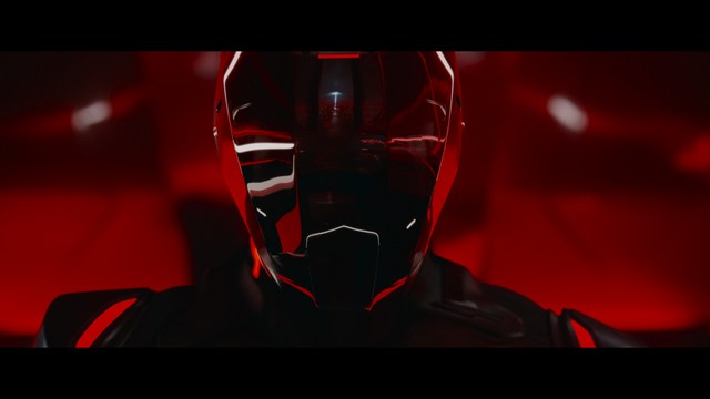 A scene from a movie featuring two young men sitting closely together in an airport waiting area, with one holding a box of popcorn.