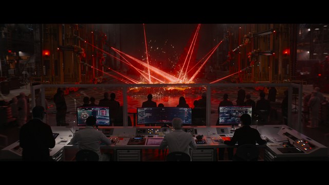 Three young individuals sitting together, two holding hockey sticks, with a casual and intense expression in a domestic setting.