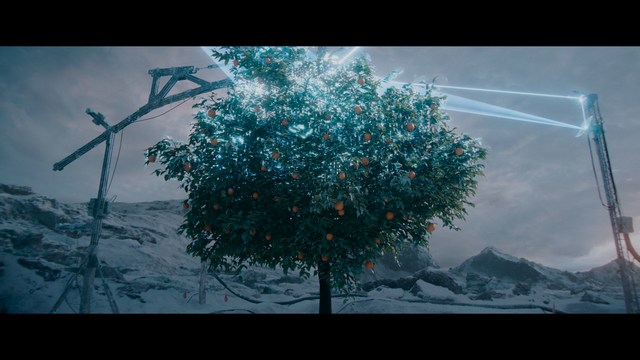 A scene from a movie featuring three characters standing on a bridge with a lush green landscape in the background.