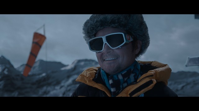 A worried woman stands on a deserted road, looking shocked or distressed as she gazes into the distance.