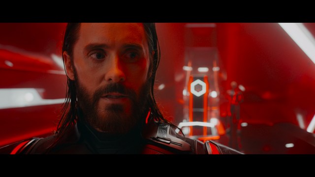 Three characters looking down with surprised expressions, framed from below.