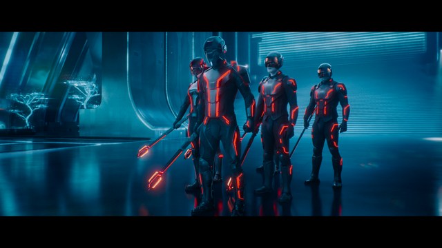 Two characters wearing red bandanas look surprised while standing in a dimly lit indoor setting.