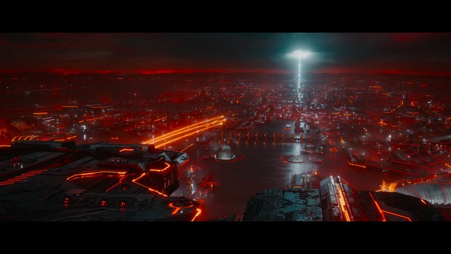 A shocked man with long hair and a baseball cap sitting in a bar, looking surprised.