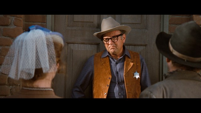 Three characters looking down in shock or concern, with a snowy background.