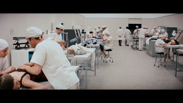 Scene from the movie featuring two characters, one with a beard and the other with long hair, both wearing red bandanas and looking surprised.