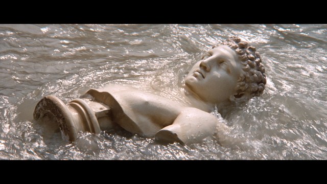Two figures walking along a highway next to a 'Welcome to New Jersey' sign, with greenery in the background.