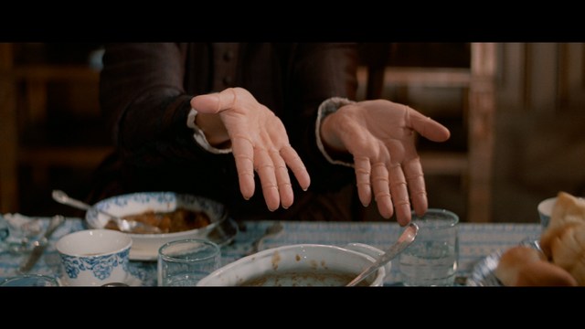 Three young individuals sitting together, two holding hockey sticks, with a casual and intense expression in a domestic setting.